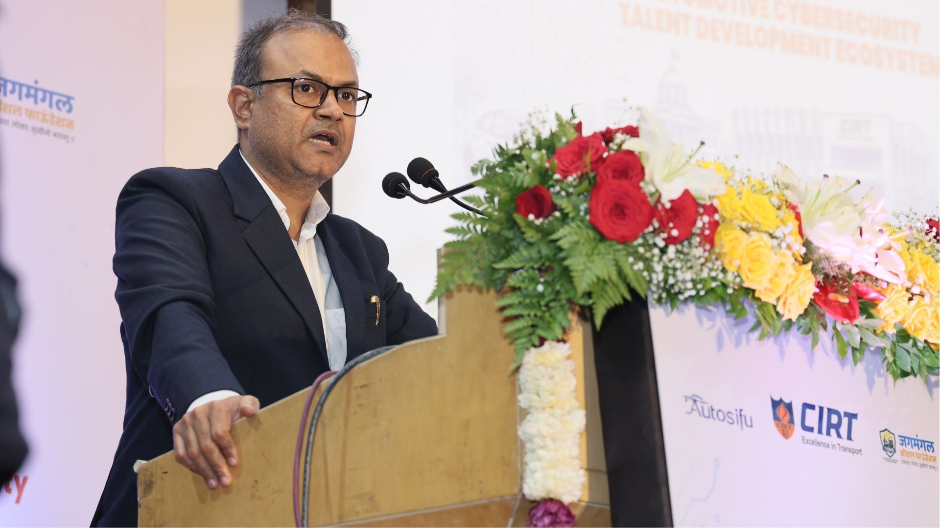 Dr. Devendra Singh speaking at the event